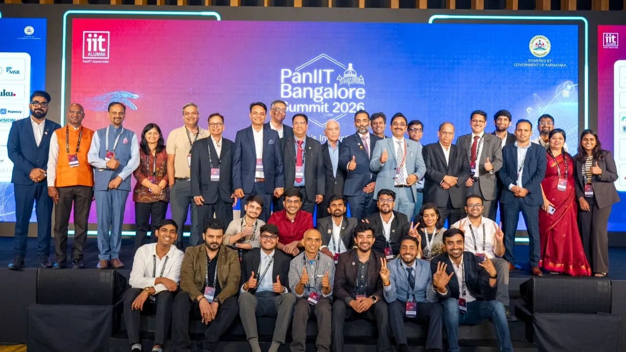 Delegates and volunteers on stage at the PanIIT Bangalore Summit 2026