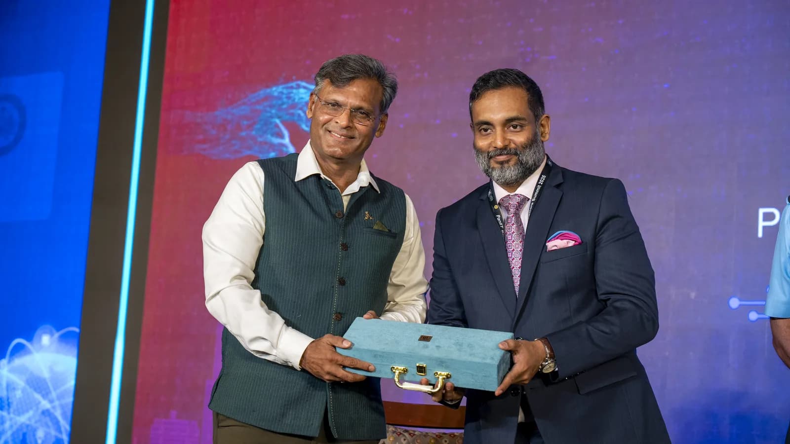 A speaker being felicitated on stage at a PanIIT Alumni India summit