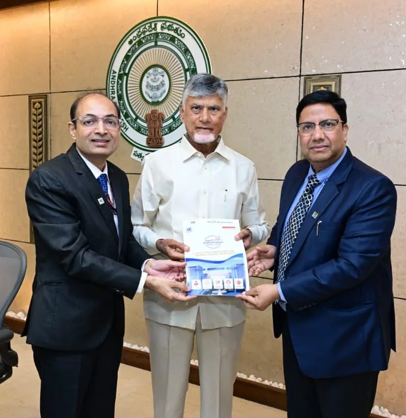 The Chief Minister of Andhra Pradesh with PanIIT Alumni India's Chairman and Vice Chairman, holding the summit brochure.