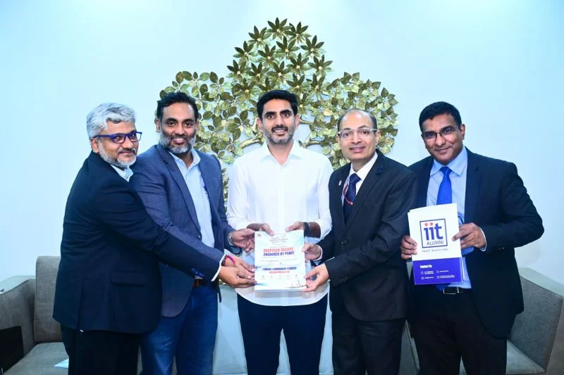 Sri Nara Lokesh, Minister for IT, receiving the PanIIT Andhra Pradesh Summit 2026 brochure from the organising team.